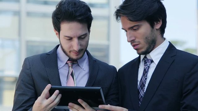 businesspeople going at work and using tablet and smartphone
