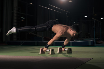 Fototapeta premium man gymanst in air, two hands cartwheel