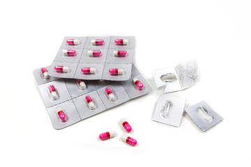 Pink and white pills in blister packs isolated on white background