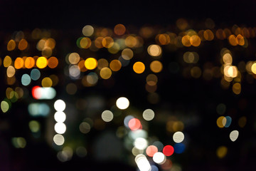 Blurred background of city lights. Bokeh with different colored lights.