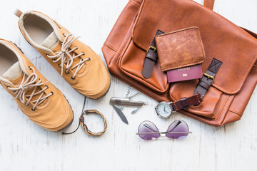 Men's casual outfits with man clothing, travel preparations and accessories on white wooden background