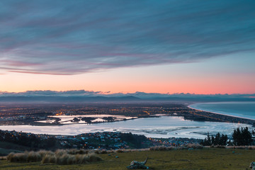 Sunset over city on ocean shore