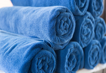 Fototapeta premium pile of rolled folded blue towel in spa