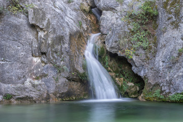 Fototapeta na wymiar Mythological Orpheus Spring with cool pond on ancient Helicon (Baphyras, Ourlia, Helikon) River. Mount Olympus, Pieria, Greece. 