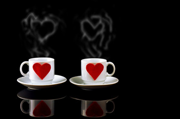 two cups with hearts and steam in the form of heart a reflection on a black background