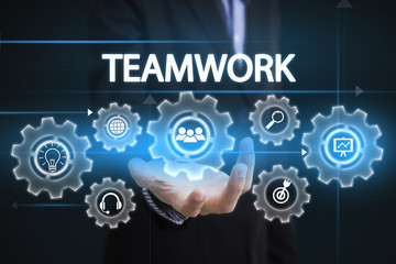 Businessman hand holding wording teamwork. sign on virtual screen. business concept.