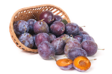Fototapeta premium plum in a wicker basket isolated on white background