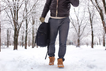 bearded man walking in a winter park