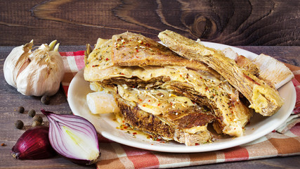 Beef meat boiled on the plate on a wooden background