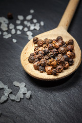 black pepper and salt on rustic stone background. Overhead view food photography