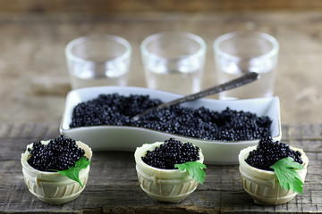 Fototapeta na wymiar black caviar on a wooden background