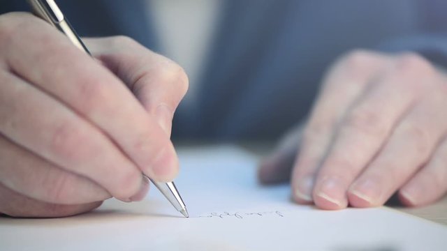 Close up of businesswoman's hands signing business contract agreement at office desk