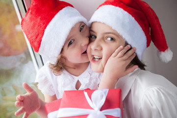 two cute little girls with Christmas gifts
