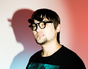 Fototapeta premium silhouette Rocker man in a funny glasses posing on red background