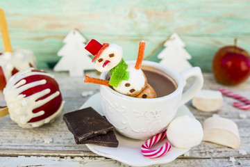Marshmallow snowman in hot chocolate. Winter sweet delicious.

