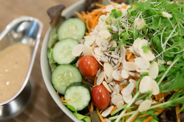 Fresh salad bowl with colorful tomatoes, cucumber, mixed greens