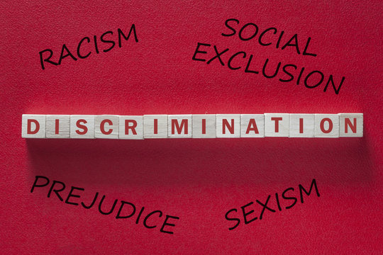 Discrimination And Other Social Issues Concept With Blocks And Words On Red Background