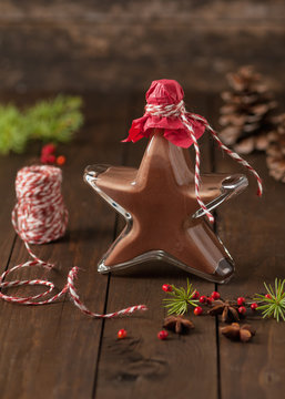 Star shaped bottle with homemade speculoos liqueur. Christmas gift.
