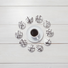 Cup of coffee and meringue on wooden background. Top view