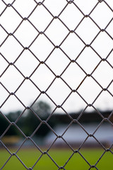 metal fences with blur stadium backgroud
