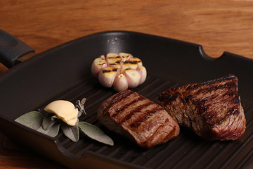 Medium rare steak on a skillet grill, homemade food.