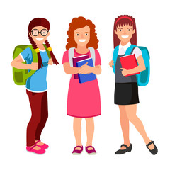 Three schoolgirls with backpacks and textbooks