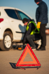 Car assistance technician repairing auto outdoors
