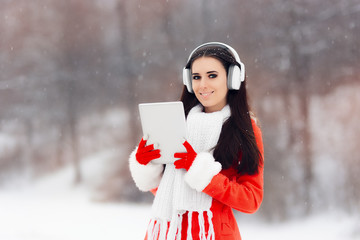 Happy Winter Girl with Headphones and PC Tablet