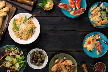 Frame of risotto, roasted chicken legs. snacks on wooden table