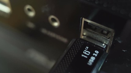 Inserting usb flash drive into computer. Macro shot 4K.