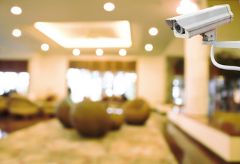 CCTV Camera on abstract blur beautiful hotel lobby background concept idea.