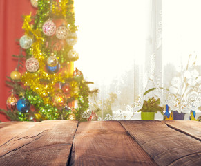 Naklejka na ściany i meble christmas table background with christmas tree out of focus