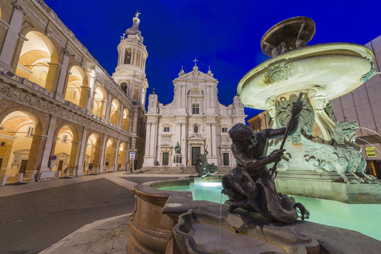 Night view of the Basilica of the Holy House and fountain decorated with statues, Loreto, Province of Ancona, Marche