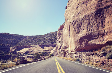 Retro toned scenic road against sun, travel concept background, Colorado, USA.