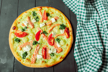 Fresh tasty pizza on wooden background