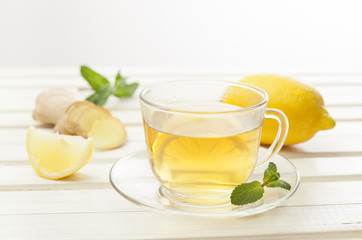 drink of lemon and ginger  on white wooden table