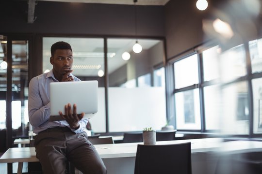 Businessman working over laptop
