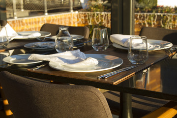 Table in the restaurand served for several persons with glasses,
