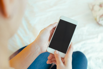 Woman with modern mobile phone in hands