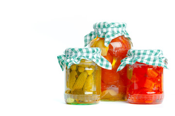 Canned vegetables in glass jars isolated on white background