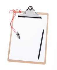 A blank clipboard and a coaches whistle with copy space