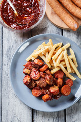 Traditional German currywurst - pieces of sausage with curry sau