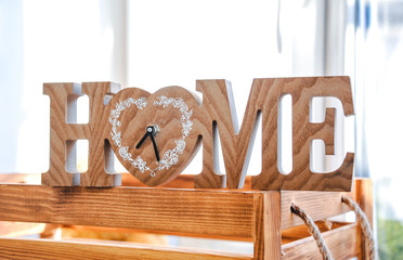 A beautiful festive decoration of the interior. Holidays. In a good mood. A sign with the word Home.
