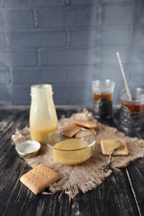 Romantic creative breakfast for two with jam, cakes and black tea on white wooden table. Food concept of love.