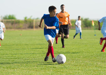 Boy kicking soccer ball