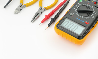 Multimeter, probes, needle nose pliers, wire cutters, screwdriver on  white background