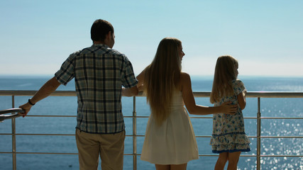 Happy family with young children standing outdoors
