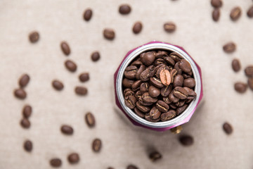 Italian moka pot full of roasted coffee beans. Top view