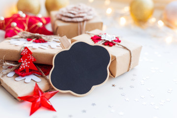 Christmas and New Year background with cloud chalkboard, presents and decorations for Christmas tree. Holiday background with stars confetti and light bulbs. Place for text.