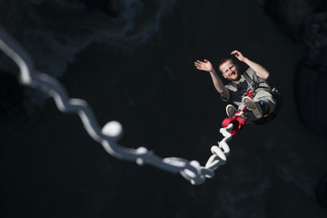 A man smiles for the camera as he is bounced back up during a Bungee jump at The Last Resort, Nepal